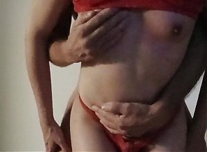 Sexy transvestite in red lingerie with real small tits gets fucked standing in front of the camera