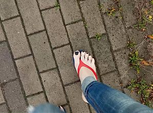 a crossdresser with sexy feet in flip flops is tempting on the street